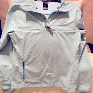 Light blue running jacket by the NorthFace
